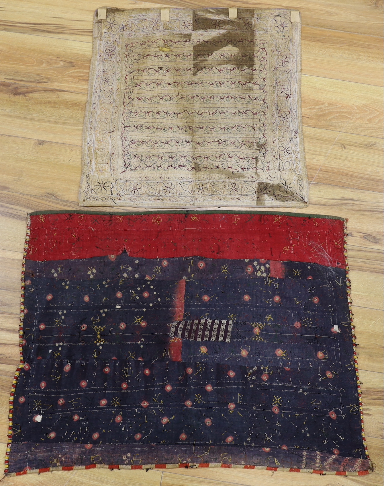 Two Indian embroidered and mirrored panels, possibly wall hangings, the largest 86cm x 67cm